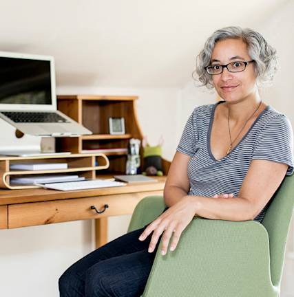 A photo of Arianne Foulks sitting at a desk.