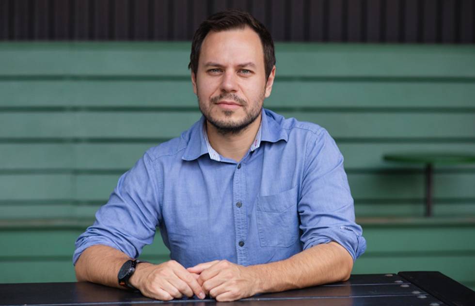 A photograph of Krešimir Končić in a blue shirt sitting at a table.