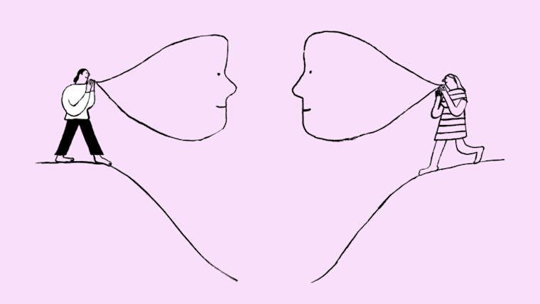 Two people talking to each other from separate, facing hills.