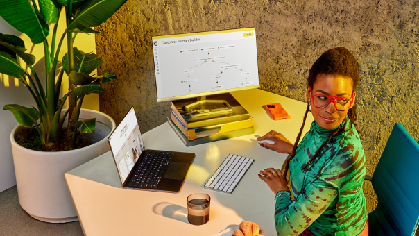 Woman working at her desk with 2 screens open