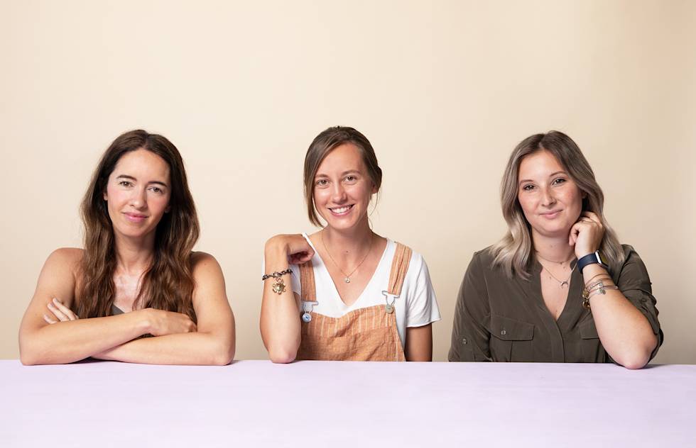 A photo of freelancers Marcy Chu, Paige Slaughter, and Mari Backus sitting together at a table.