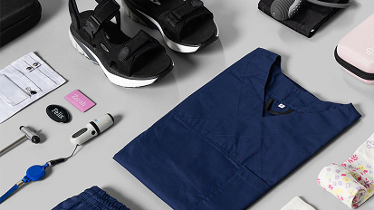 Flat lay collection of navy blue and black business items including clothing, accessories, and electronics on light gray background