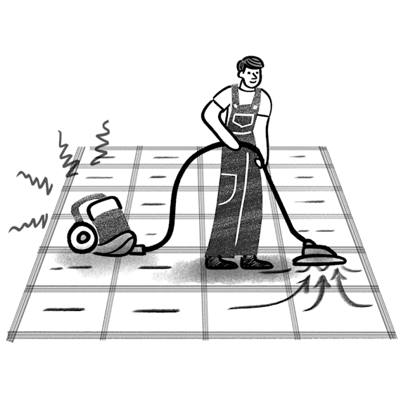 Man in overalls vacuuming a rug