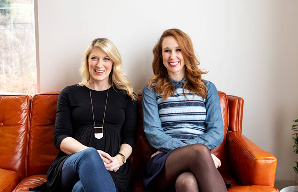 Photo of the Rhyme & Reason business owners on a couch.