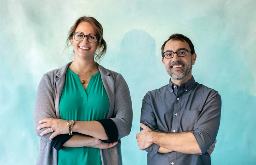 A man and a woman standing next to each other in a photograph