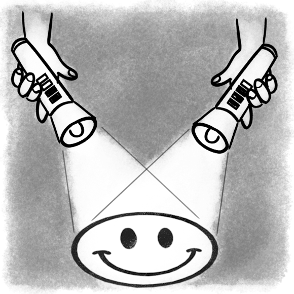 Two flashlights illuminating a smiley face