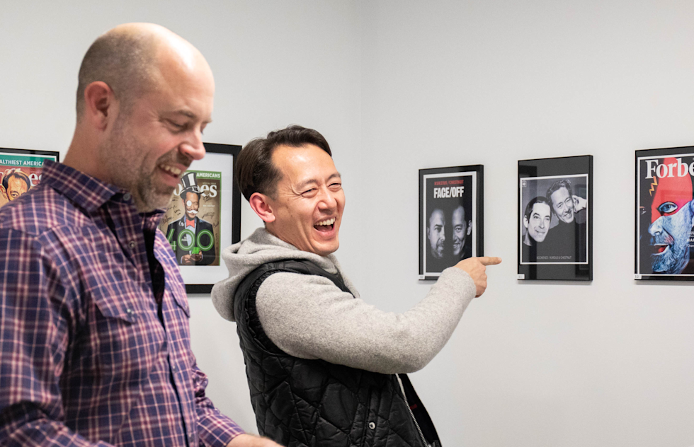 A photograph of Ben and Dan looking at the employee art