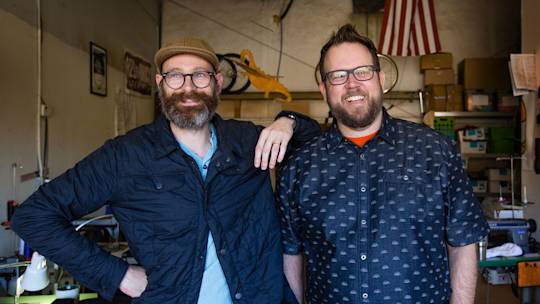 Two gentlemen looking happy in their workspace. Would that we could all have their casual camaraderie.