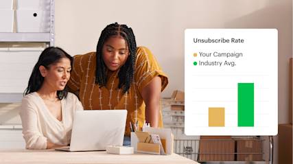 Two coworkers examining a report that compares the unsubscribe rate on their latest campaign against the industry average. 