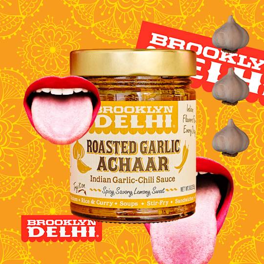 Jar of Brooklyn Delhi Roasted Garlic Achaar sauce with garlic bulbs and tongue graphics on orange floral pattern background