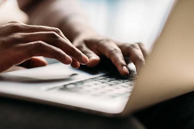 Typing on laptop