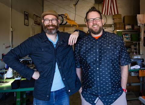 Two gentlemen that own a small business having a fun casual time. The camera captures this perfectly.