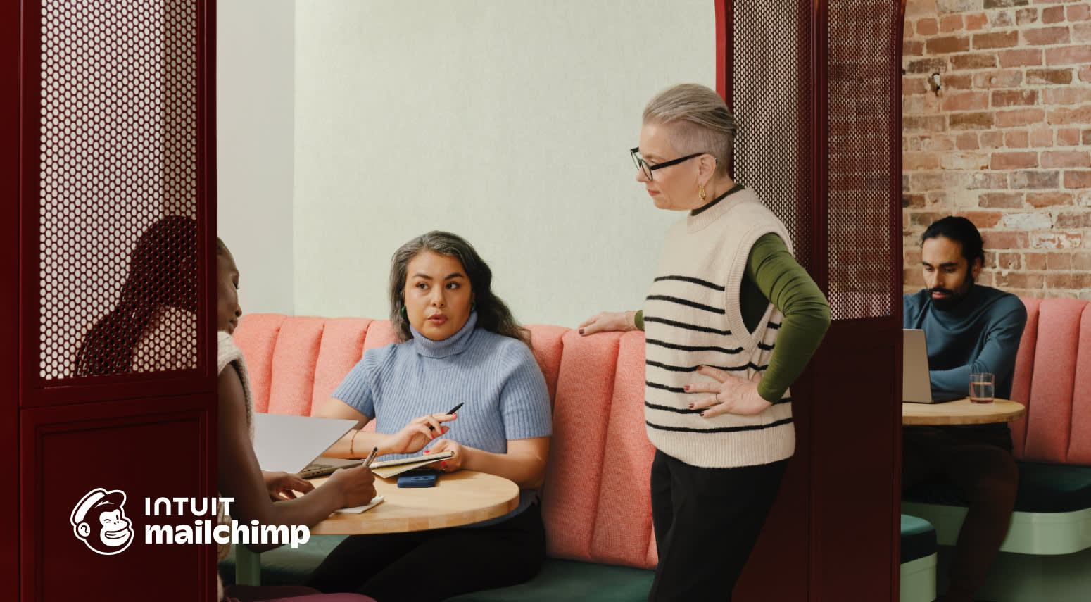 3 people discussing business in a cafe booth