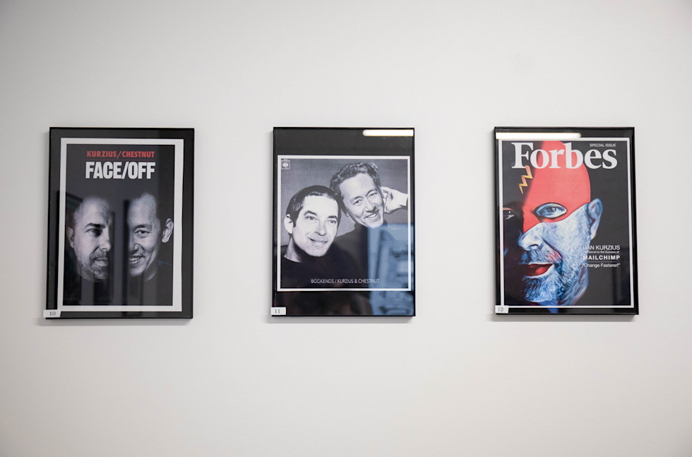 A photograph of Ben laughing a picture with Farrah in the background