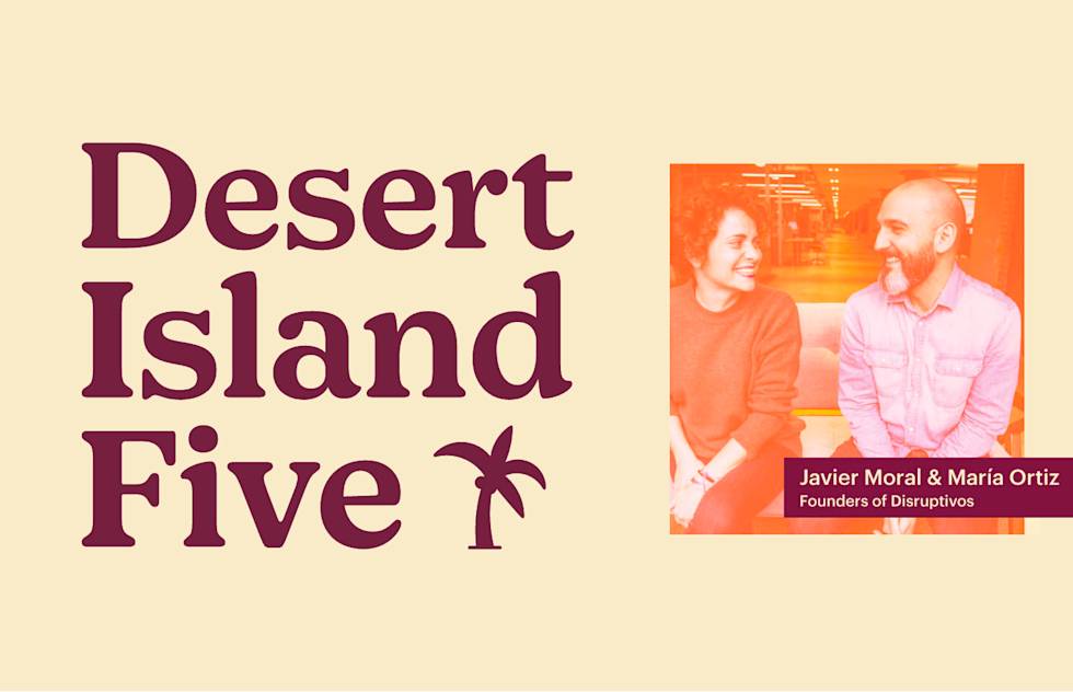 Desert Island Five title with palm tree icon and orange-tinted photo of two people smiling at each other, labeled as Disruptivos founders