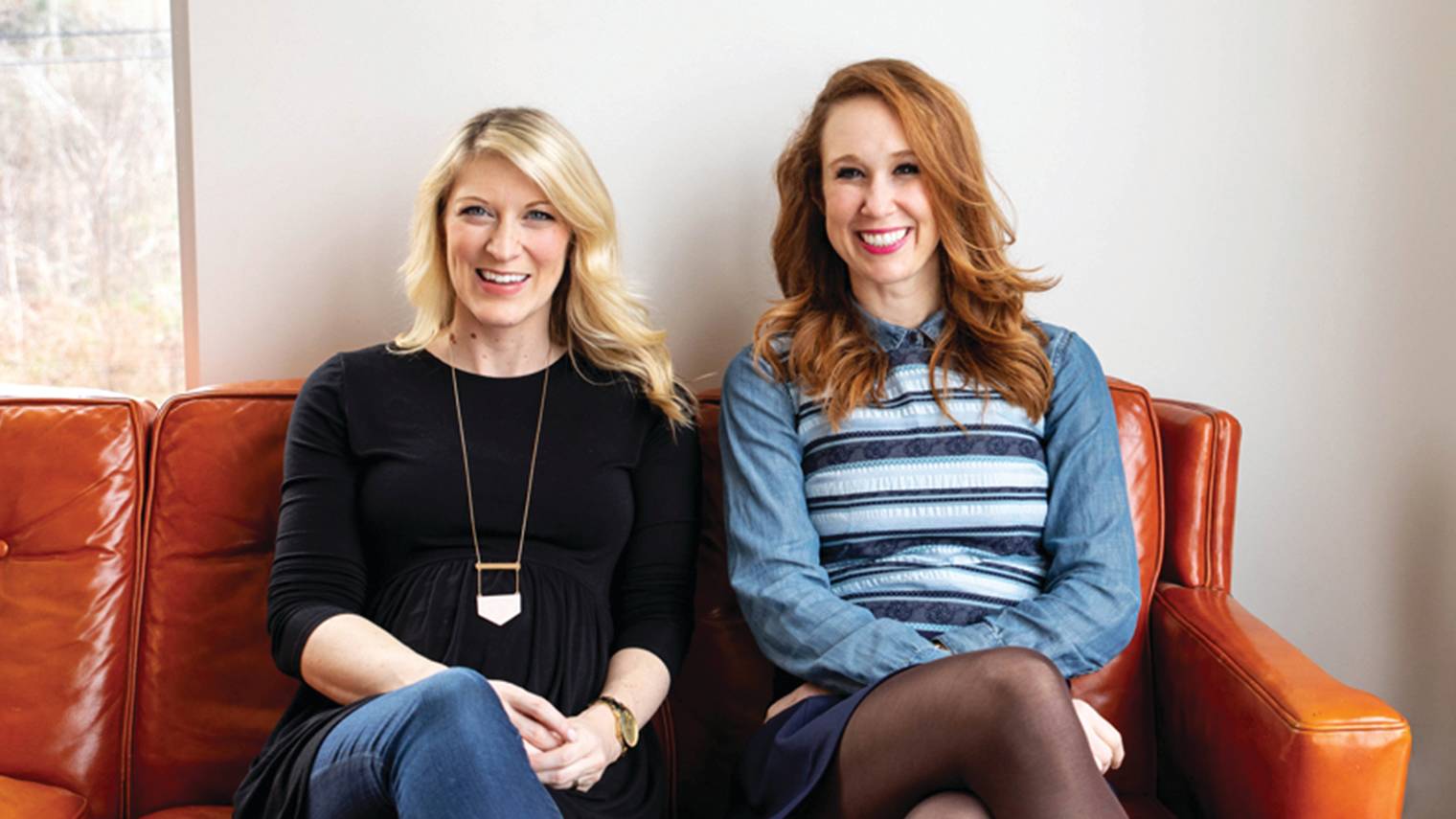 Photo of business owners on a couch. 