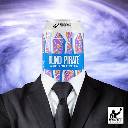 A beer can of Blind Pirate Blood Orange IPA wearing a black suit and tie against a swirling purple cosmic background