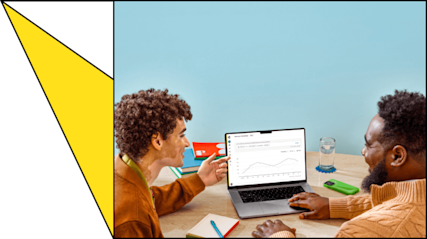 Employees discussing statistics on laptop