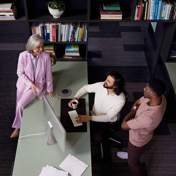 3 people discussing sales in an office
