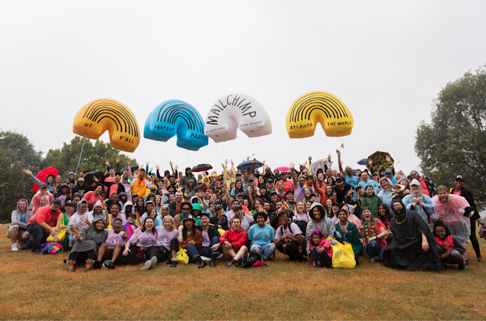 Mailchimp employees posing for a group photo at the end of the Atlanta Pride Parade in Piedmont Park.