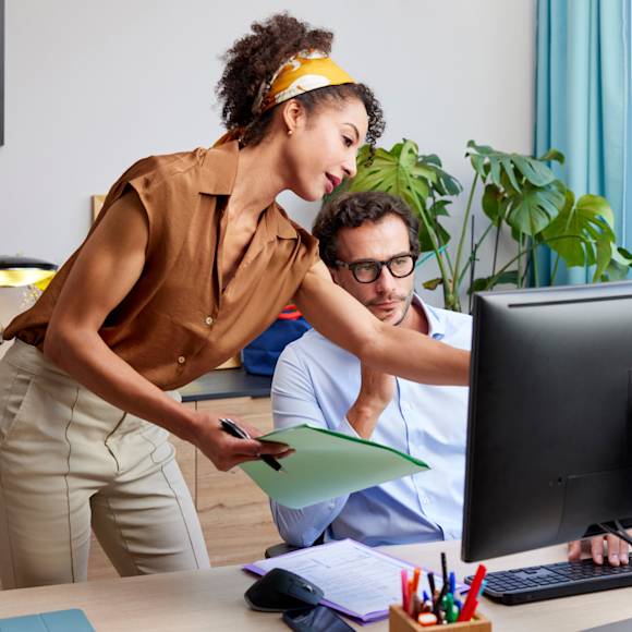 Coworkers collaborate and look at screen
