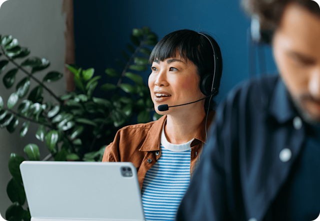 Image of a person sitting at a desk, on the phone. The visual suggests how Mailchimp experts can help with template design, full-service campaign management, and more.