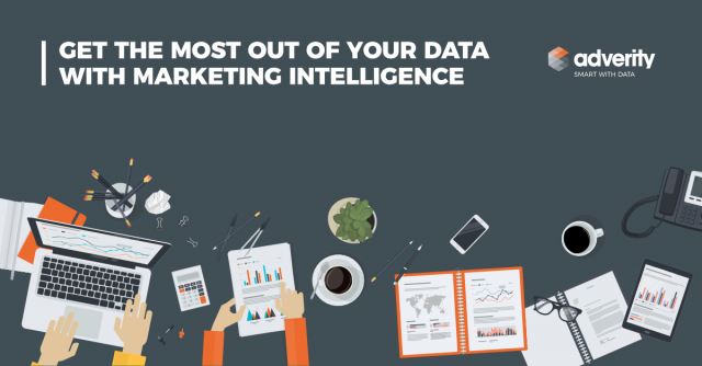 Image of a table top with a laptop, calculator, notebooks, coffee mug, cell phone.