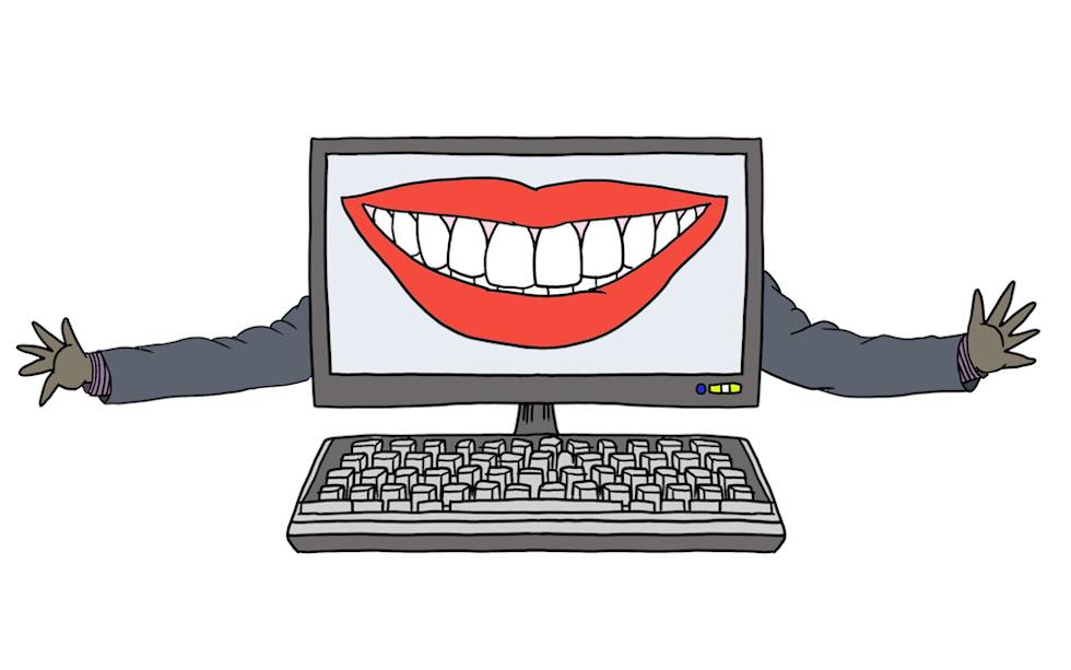 Computer monitor displaying a large smiling mouth with white teeth, with cartoon arms extending outward from its sides and a keyboard below