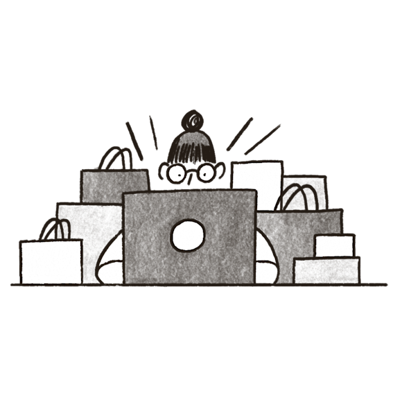 woman shopping on laptop with shopping bags surrounding her