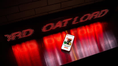 A series of connected images showing a smartphone displaying the Target app against a backdrop of red and white illuminated LED lights