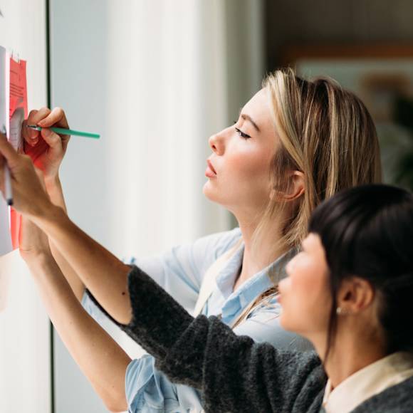 Two coworkers prioritizing tasks