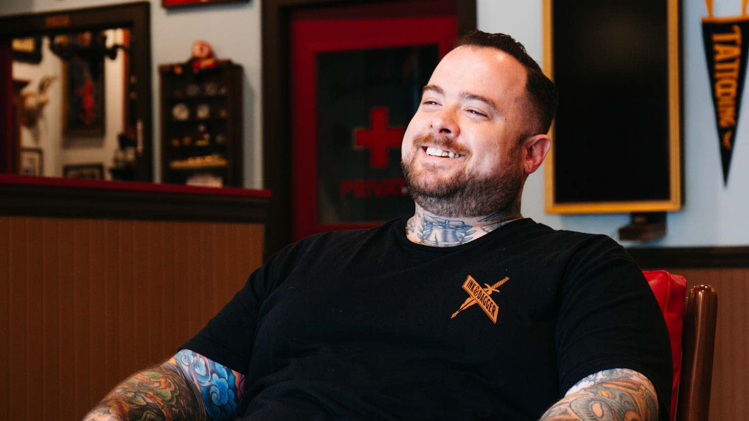 Russ Abbott smiles while being interviewed.