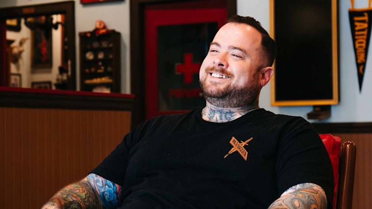 Russ Abbott smiles while being interviewed.