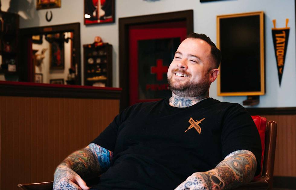 Russ Abbott smiles while being interviewed.